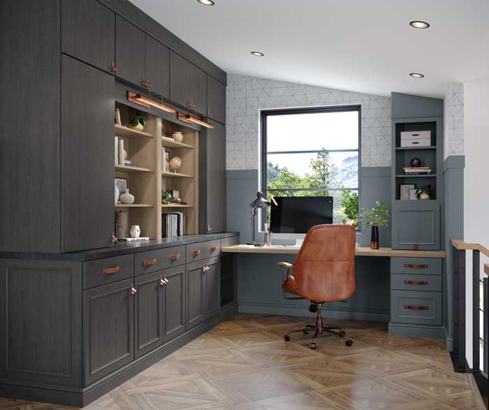 home office with dark blue cabinetry and leather chair