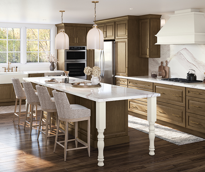 traditional kitchen with stained cabinets and island with contrasting wood hood and cabinet leg accent